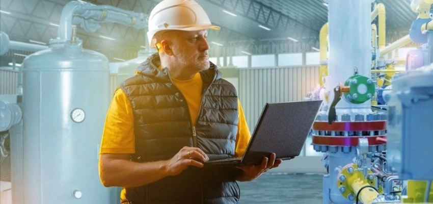Engineer inspecting industrial equipment to improve energy efficiency and operational performance in Qatar