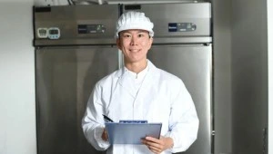 Food safety professional reviewing hygiene and HACCP controls in a commercial kitchen environment